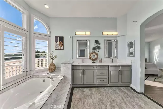 a large bathroom with a large tub and sink