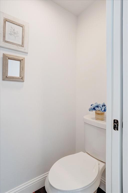 402 West Sam Rayburn Drive Ector, TX 75439 - Photo 12 of 40 a white toilet sitting next to a white sink