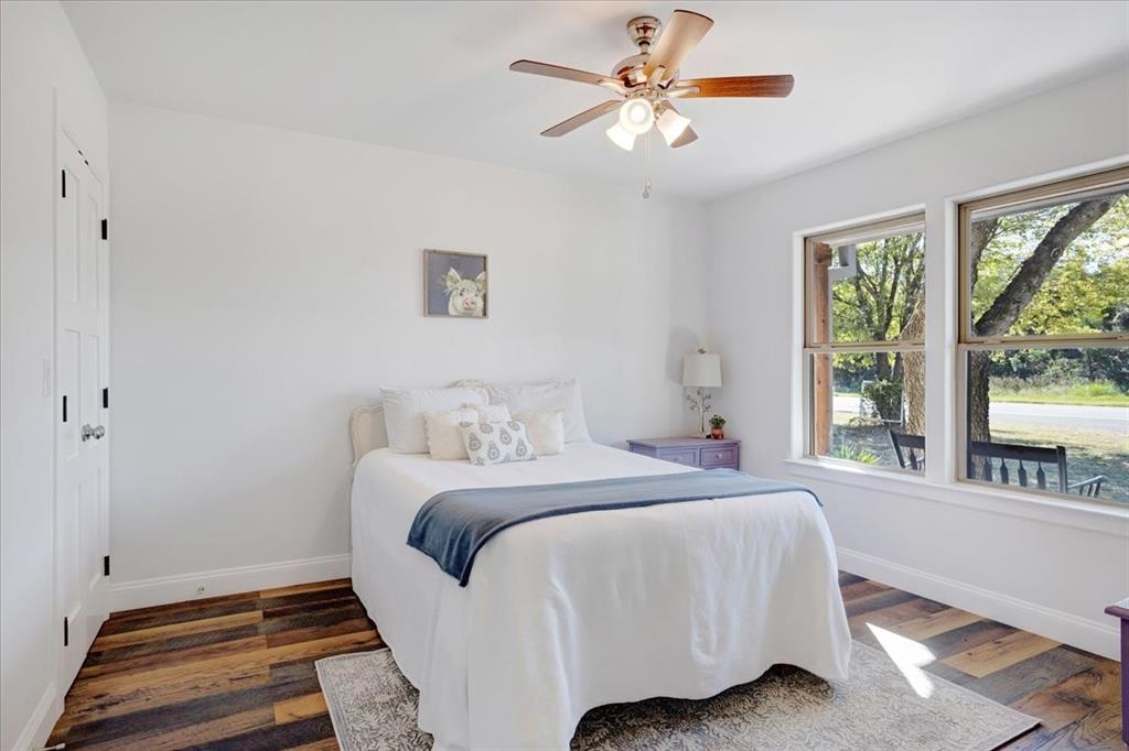 402 West Sam Rayburn Drive Ector, TX 75439 - Photo 13 of 40 a bedroom with a large bed and a window