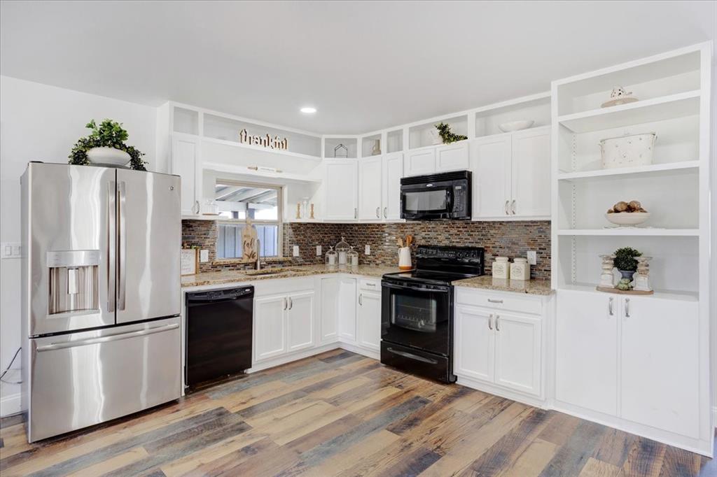 402 West Sam Rayburn Drive Ector, TX 75439 - Photo 15 of 40 a kitchen with a refrigerator stove and microwave