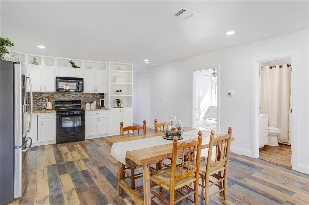 402 West Sam Rayburn Drive Ector, TX 75439 - Photo 18 of 40 a large kitchen with a table and chairs