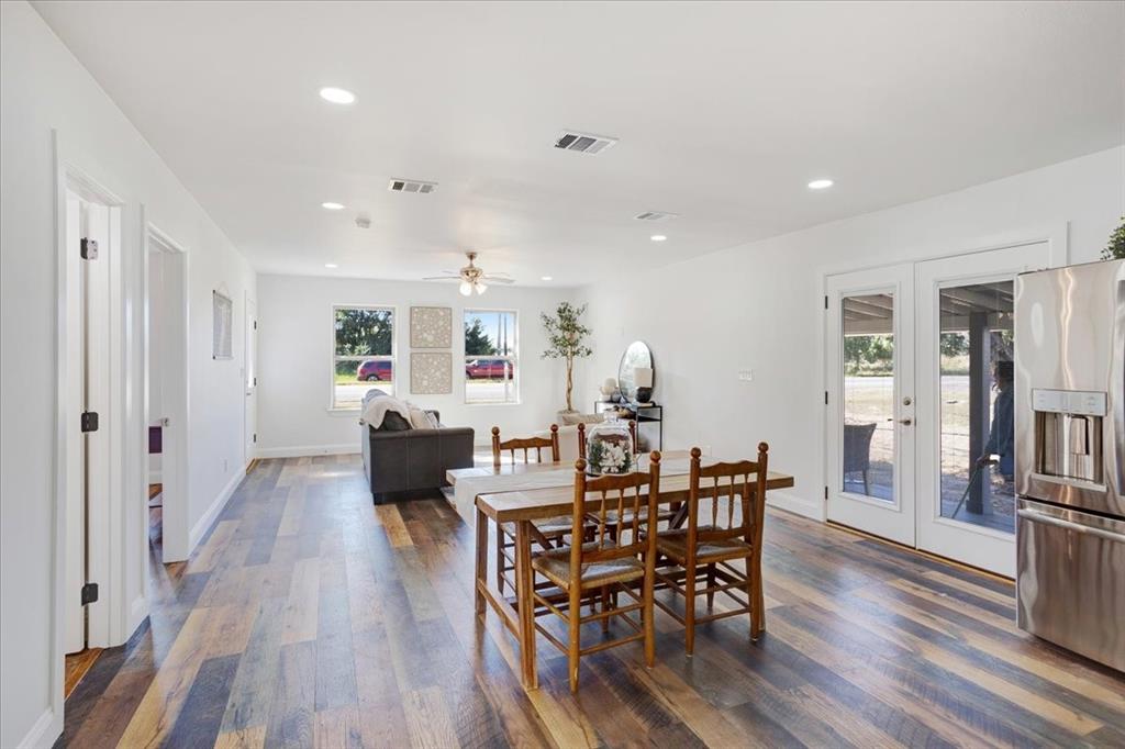 402 West Sam Rayburn Drive Ector, TX 75439 - Photo 20 of 40 a view of a dining room with furniture and wooden floor