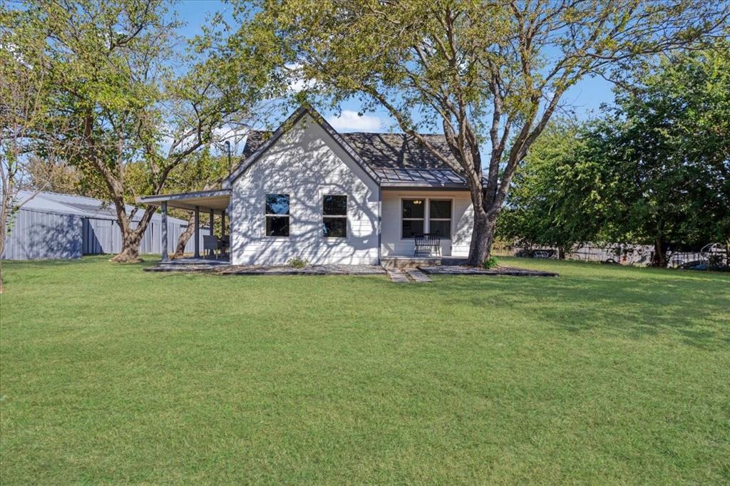 402 West Sam Rayburn Drive Ector, TX 75439 - Photo 2 of 40 a front view of house with yard and green space