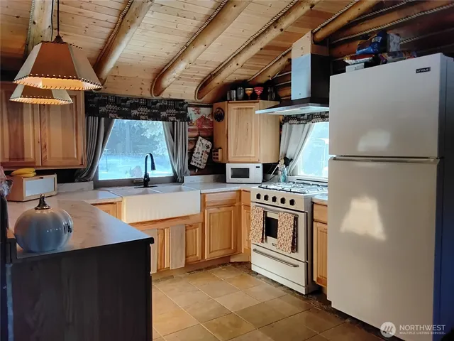 a stove top oven sitting inside of a kitchen