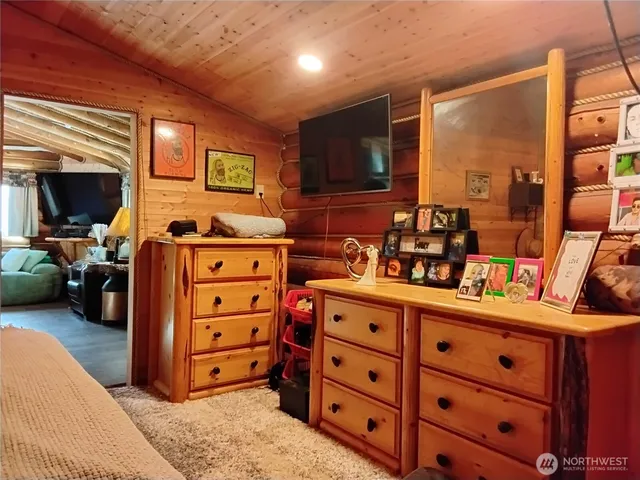 a bedroom with a bed and a couch