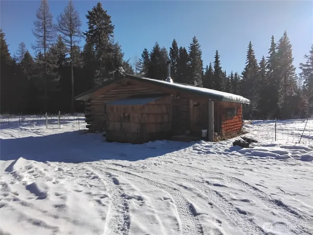 a view of backyard with wooden fence