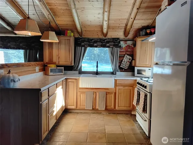 a kitchen with a refrigerator and a stove