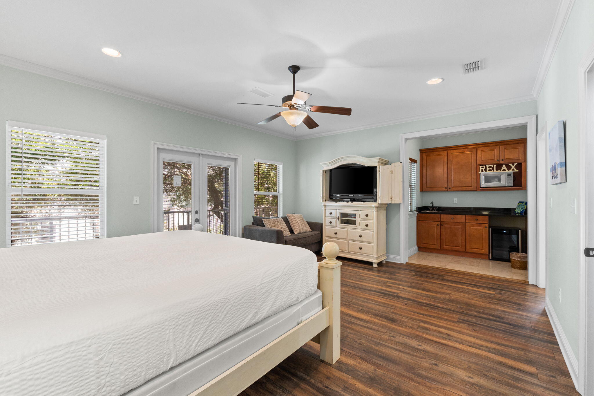 209 Grand Key Loop East Destin, FL 32541 - Photo 17 of 59 a spacious bedroom with a bed a flat screen tv and a fireplace