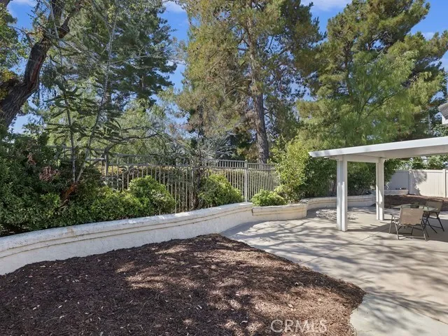 a view of a patio with table and chairs with wooden fence and floor