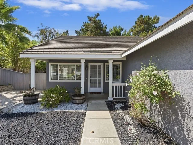 a view of a house with a small yard and plants