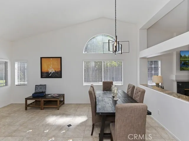 a living room with furniture a window and a flat screen tv