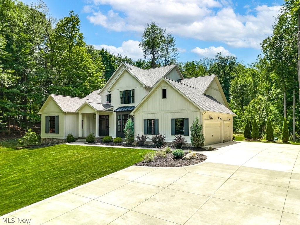3040 Lander Road Pepper Pike, OH 44124 - Photo 2 of 38 Modern farmhouse style home featuring a garage and a front yard