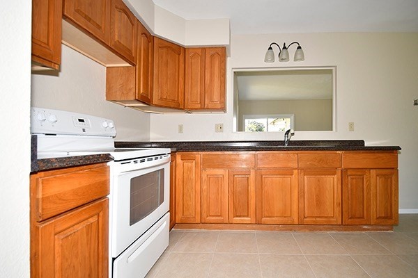 17-239 Volcano Road Keaau, HI 96749 - Photo 7 of 25 a kitchen with granite countertop a sink and cabinets