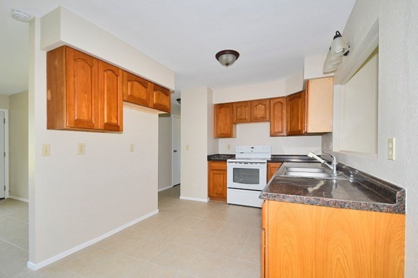 17-239 Volcano Road Keaau, HI 96749 - Photo 8 of 25 a kitchen with granite countertop a sink stainless steel appliances and cabinets