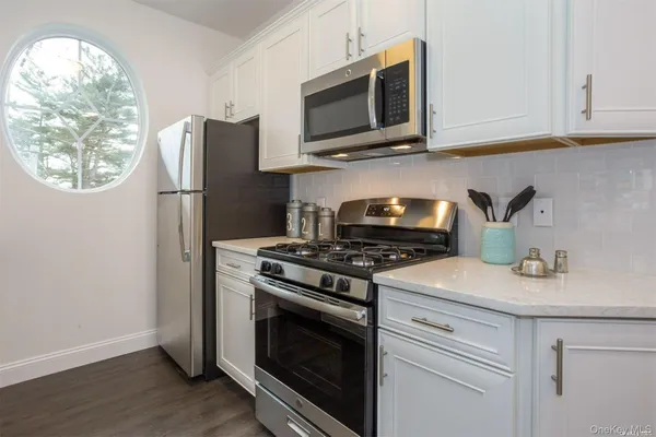 a kitchen with a stove and a microwave