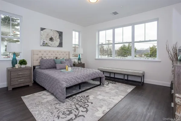 a bedroom with furniture and a large window