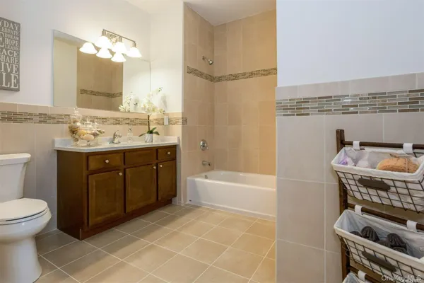 a bathroom with a sink a toilet and bathtub