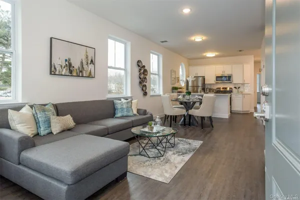 a living room with furniture and kitchen view