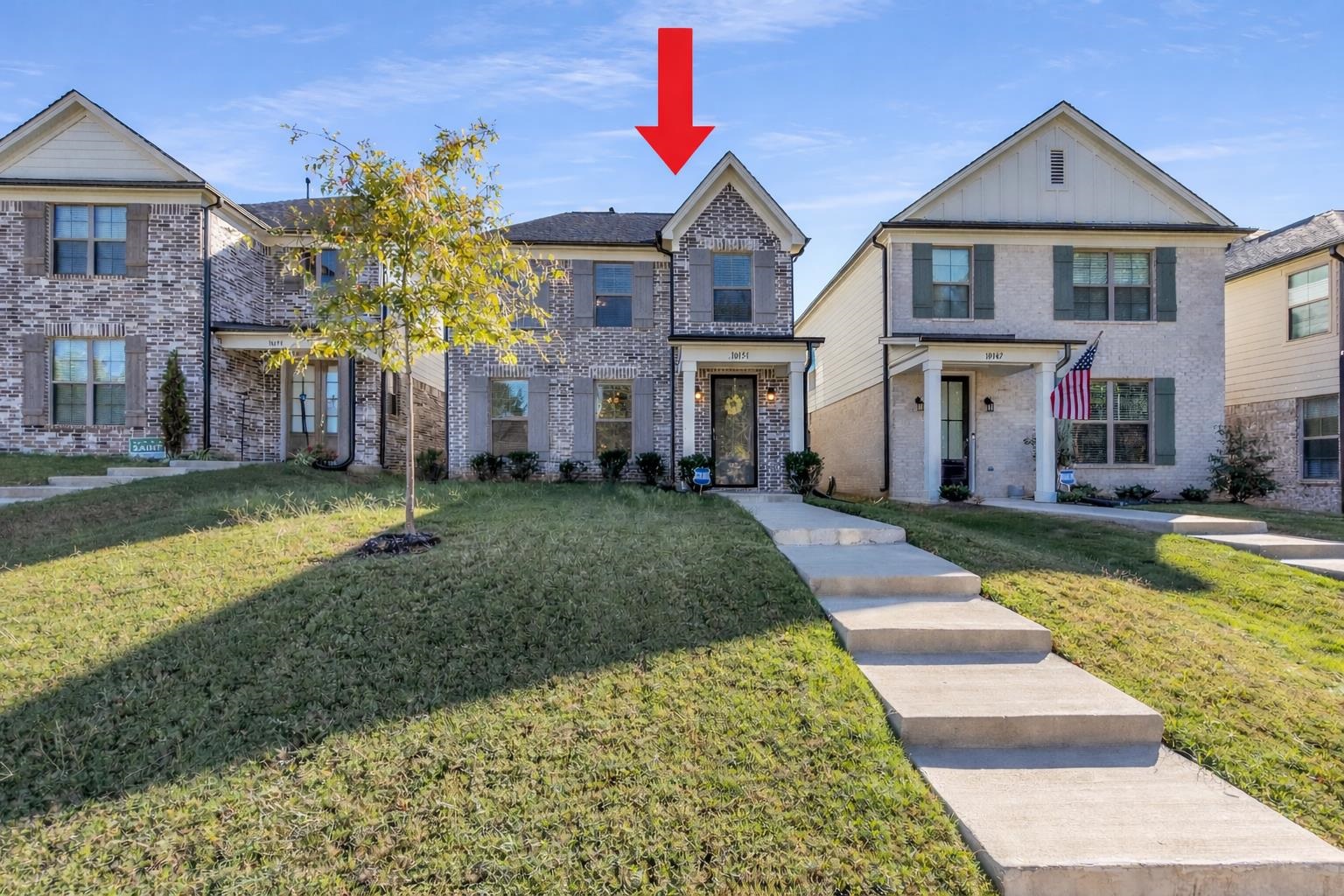 10151 Macon Road Cordova, TN 38018 - Photo 1 of 36 View of front of house featuring a front yard, brick siding, and board and batten siding