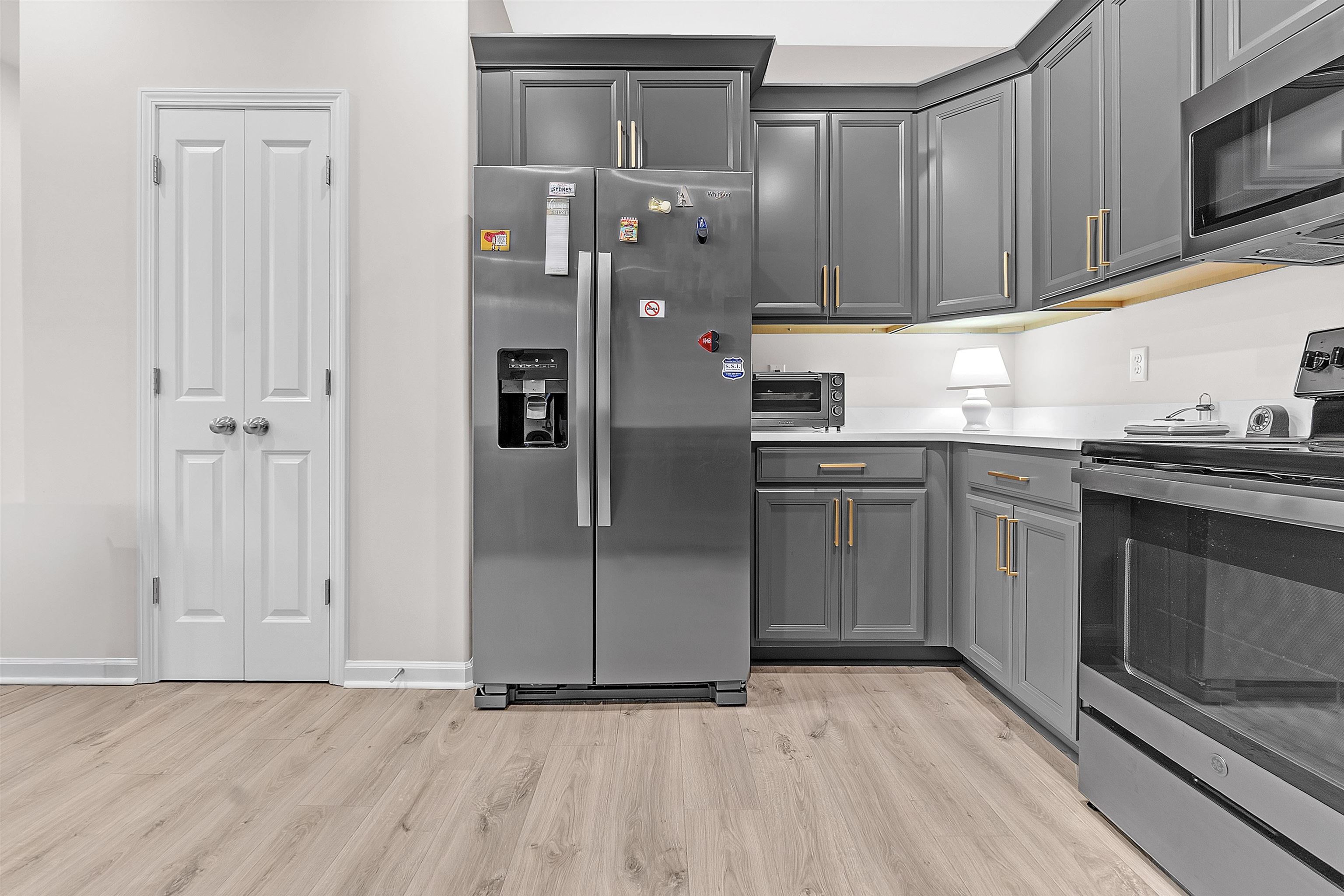 10151 Macon Road Cordova, TN 38018 - Photo 15 of 36 Kitchen featuring appliances with stainless steel finishes, gray cabinetry, and light wood-style floors