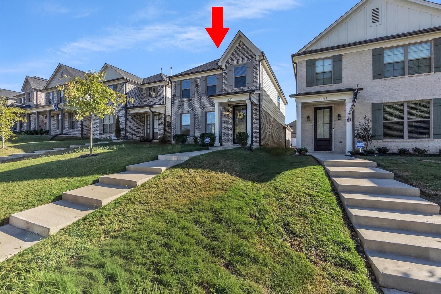 10151 Macon Road Cordova, TN 38018 - Photo 2 of 36 View of front of property with board and batten siding, a residential view, a front yard, and brick siding