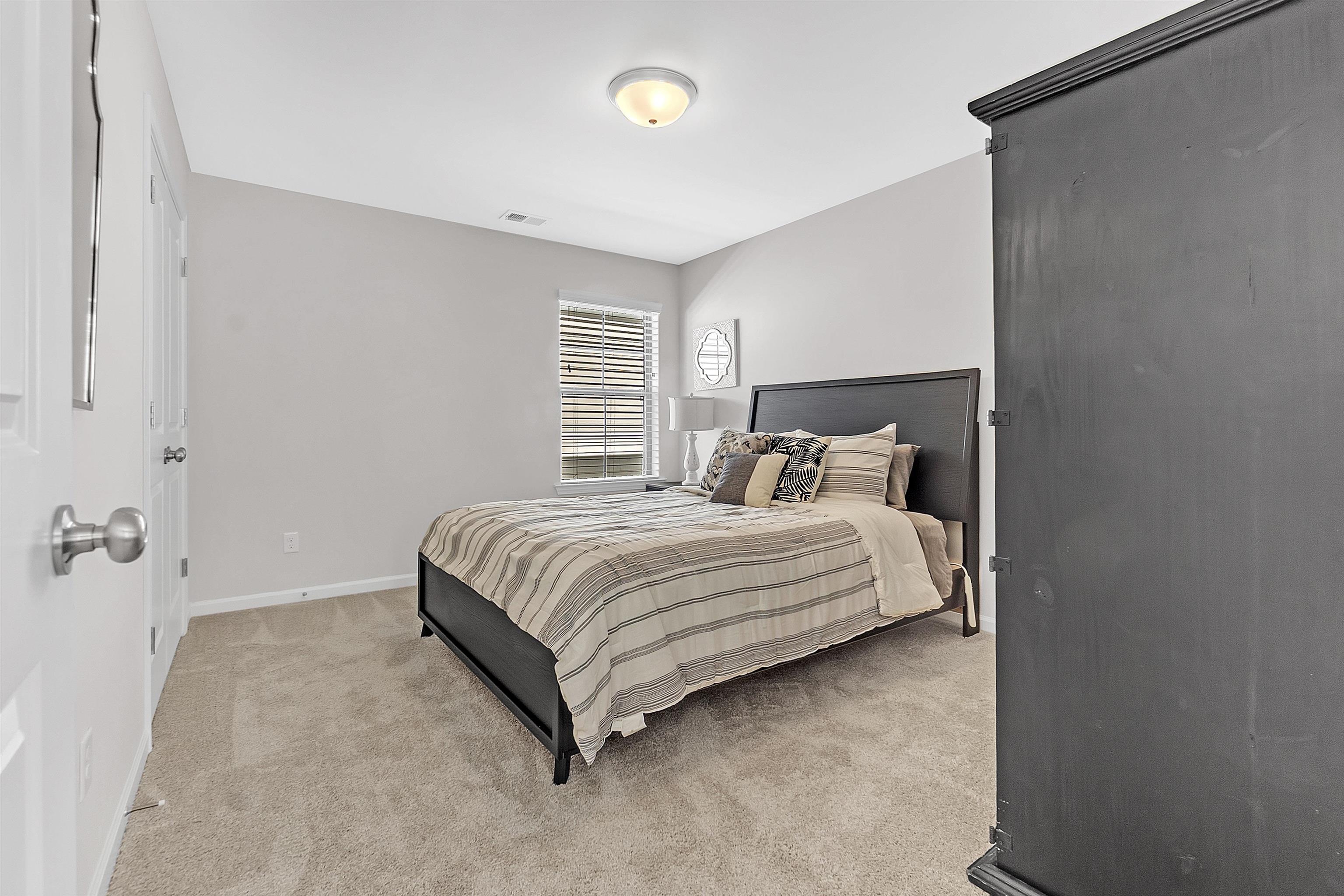 10151 Macon Road Cordova, TN 38018 - Photo 27 of 36 a bedroom with a bed and a night stand