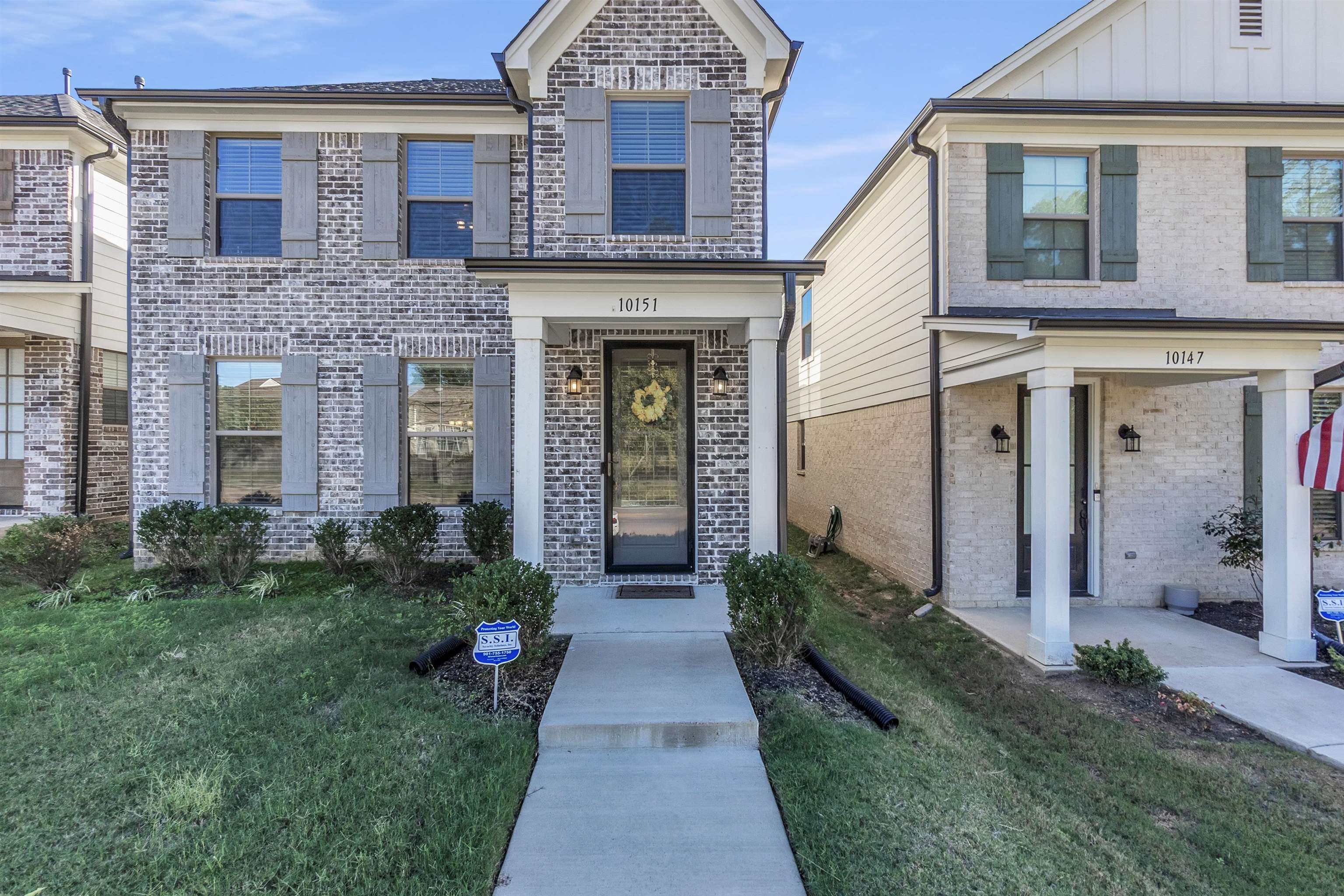 10151 Macon Road Cordova, TN 38018 - Photo 3 of 36 View of front of house with a front yard, brick siding, and board and batten siding