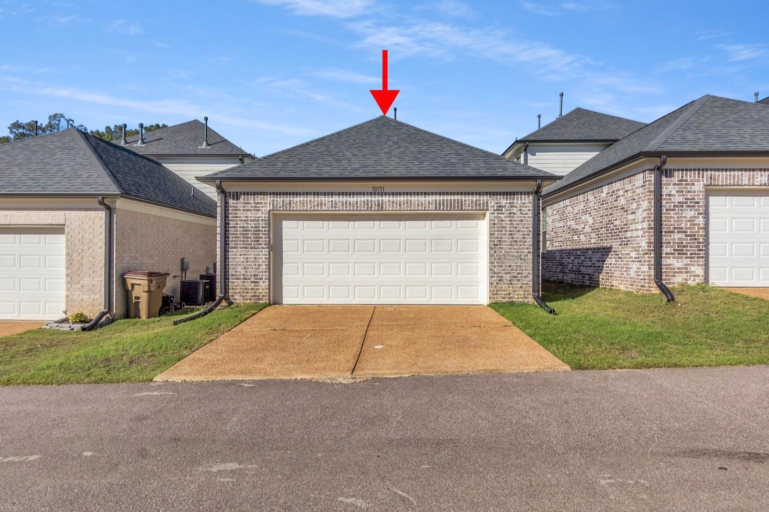 10151 Macon Road Cordova, TN 38018 - Photo 31 of 36 View of front of house featuring a shingled roof, a garage, brick siding, concrete driveway, and a front yard