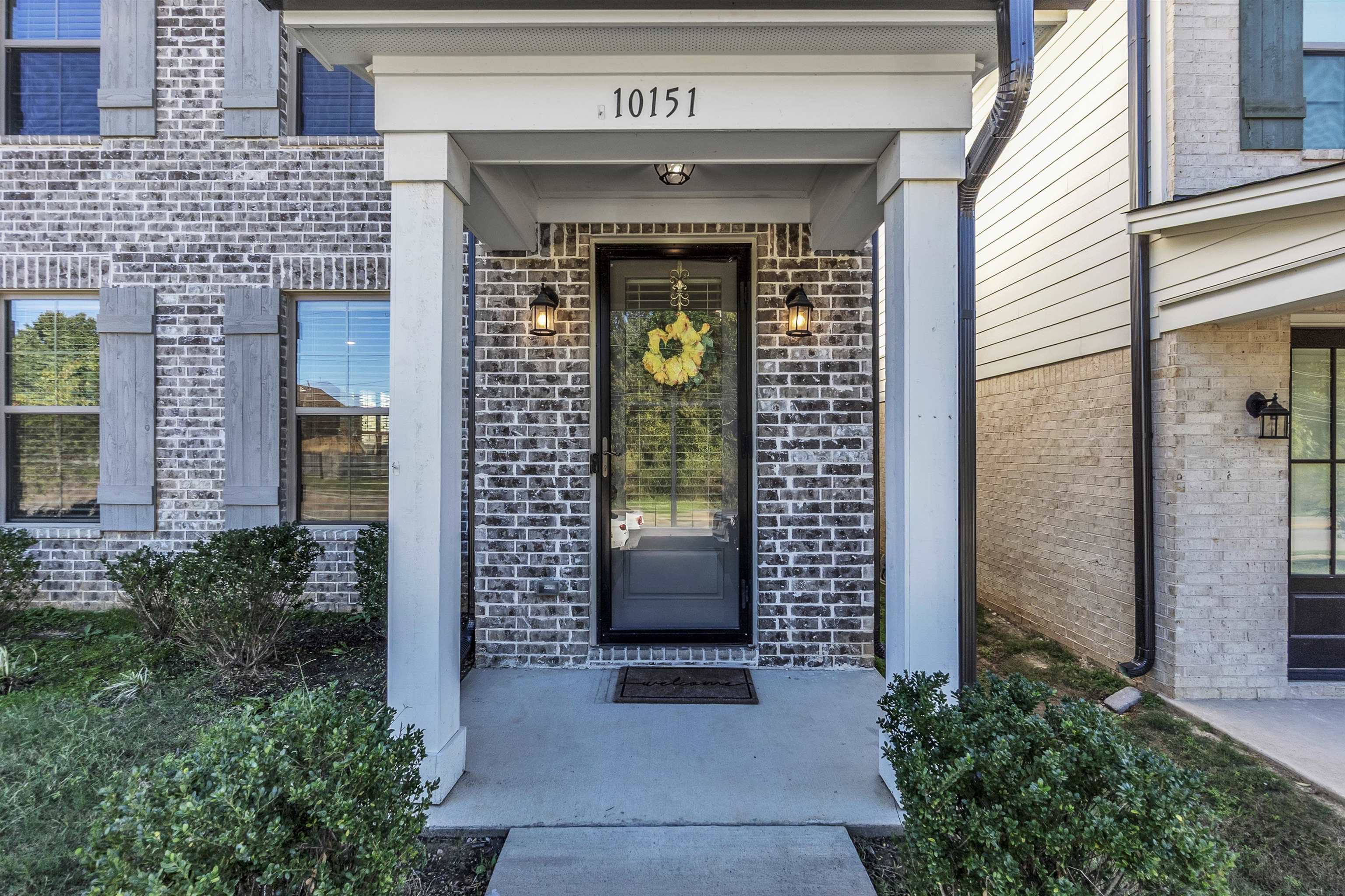 10151 Macon Road Cordova, TN 38018 - Photo 4 of 36 a front view of a house with a balcony