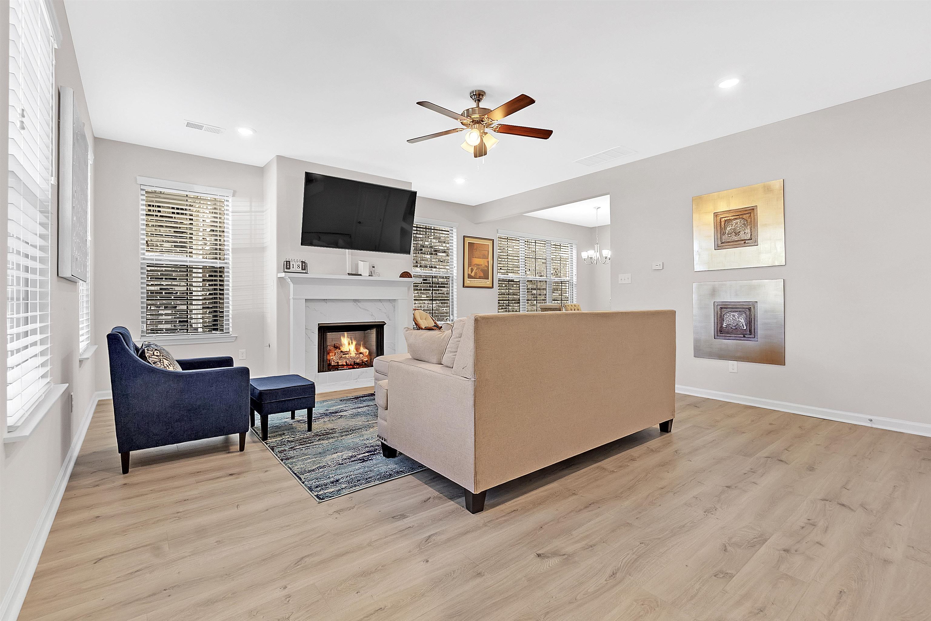 10151 Macon Road Cordova, TN 38018 - Photo 6 of 36 a living room with furniture a flat screen tv and a fireplace