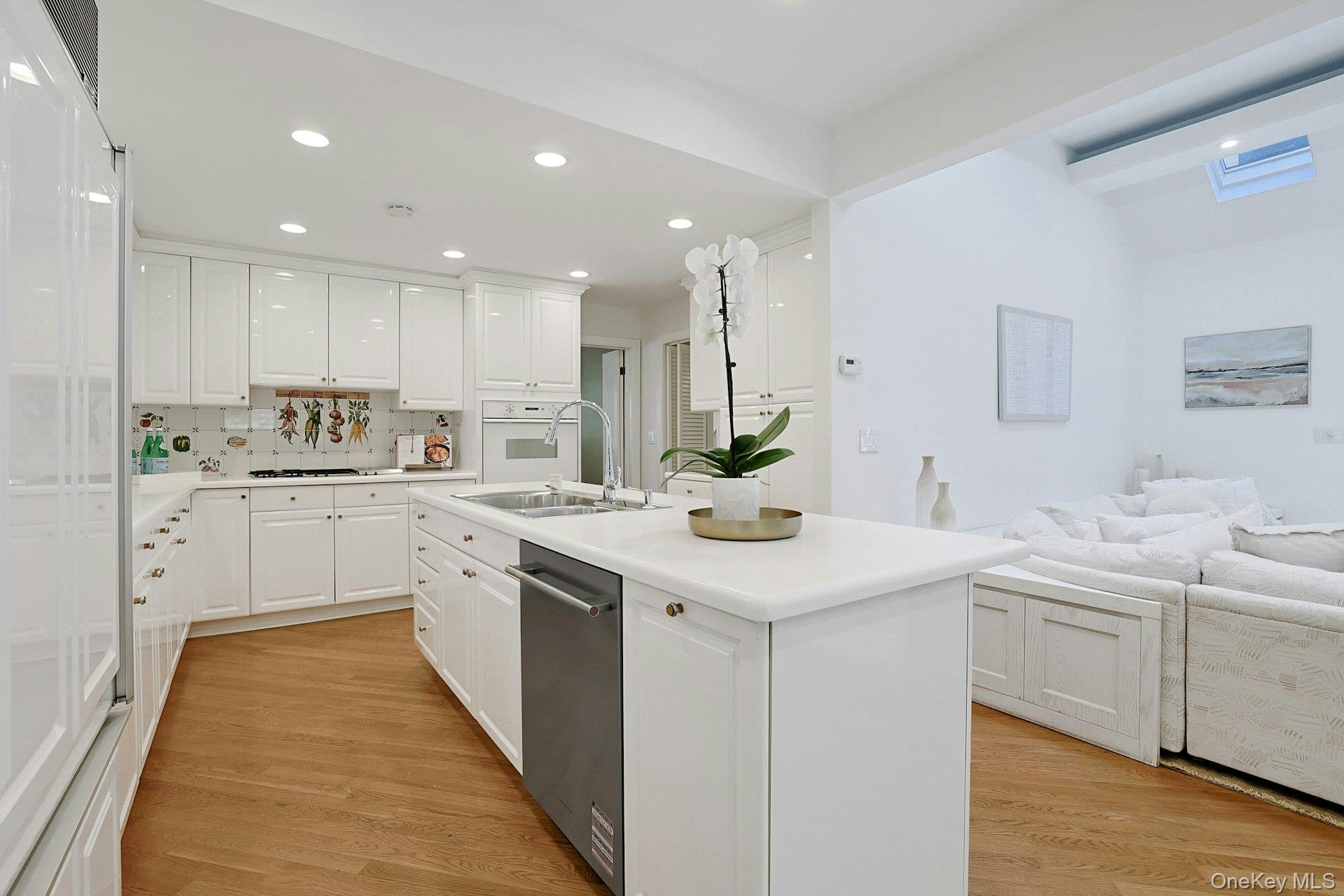 17 Elm Road Scarsdale, NY 10583 - Photo 11 of 38 The kitchen opens seamlessly to the expansive family room beyond, creating an ideal layout for both busy everyday life and entertaining.