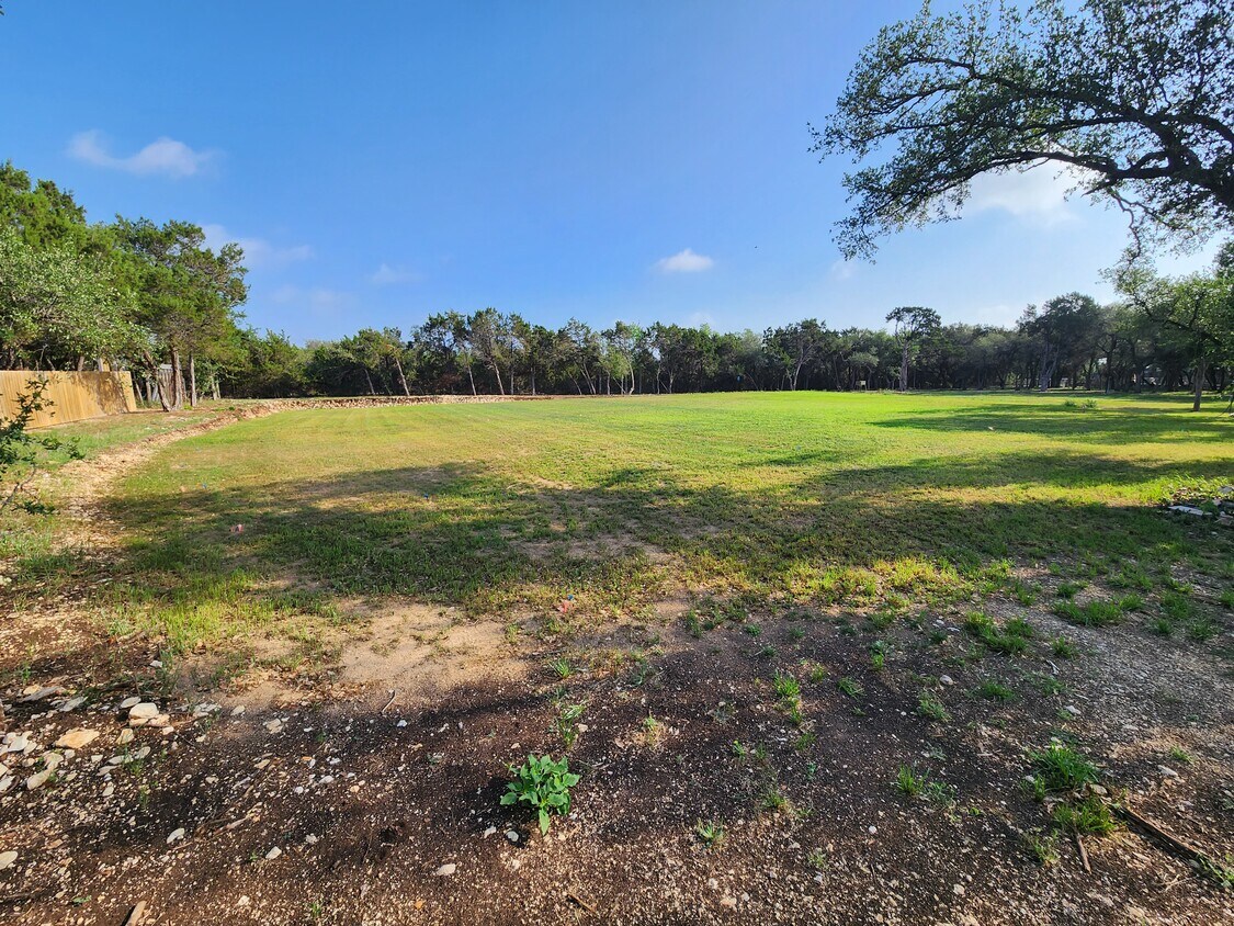 102 County Road 180 Leander, TX 78641 - Photo 19 of 25 A verdant, cleared lot bordered by mature trees awaits your vision.