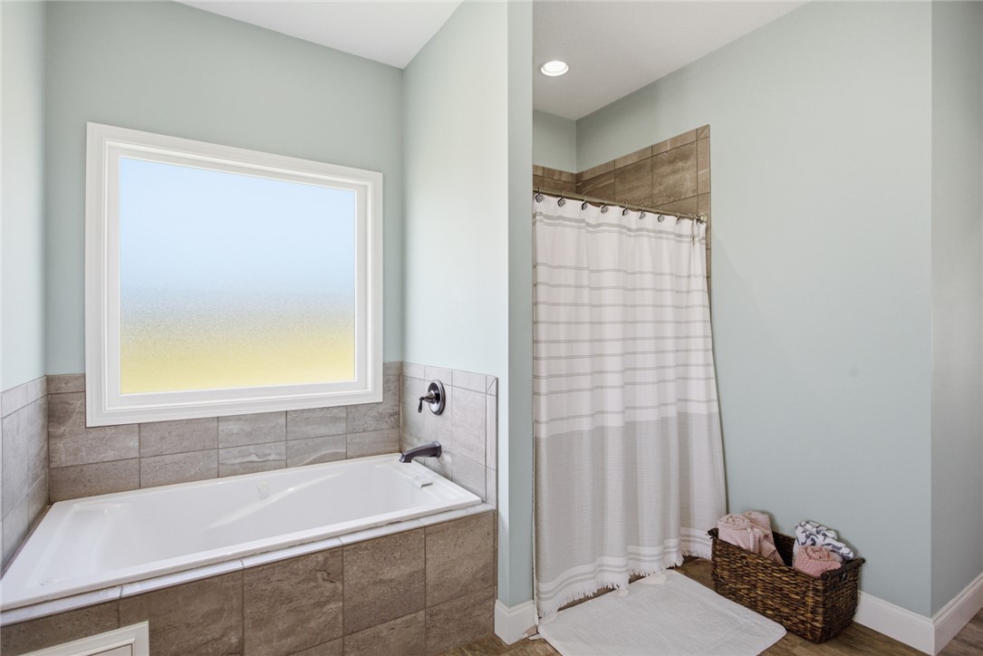 426 Oak Creek Road Seneca, SC 29678 - Photo 19 of 50 This serene bathroom offers a clean design with ample light and essential bathing features.