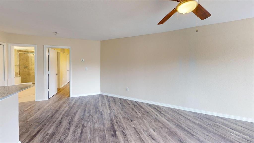 9837 Walnut Street, Unit 103 Dallas, TX 75243 - Photo 8 of 10 Spare room featuring light wood-style floors and ceiling fan