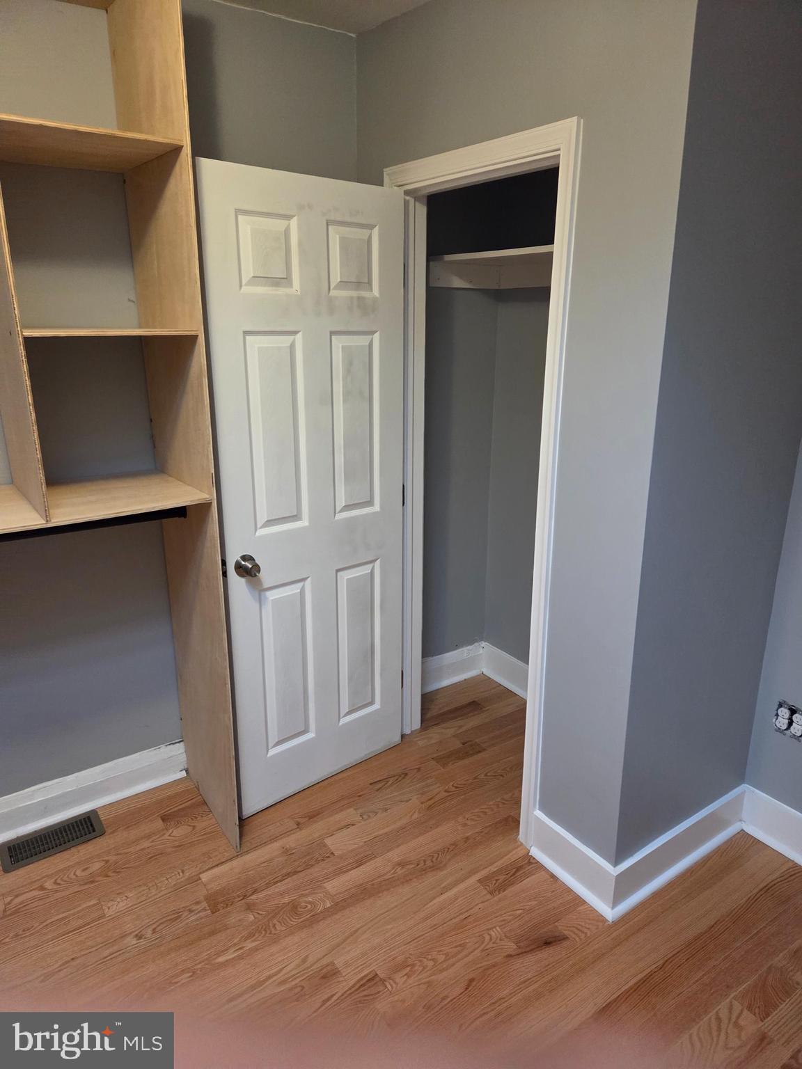 2609 East Hoffman Street Baltimore, MD 21213 - Photo 17 of 22 an empty room with wooden floor and closet