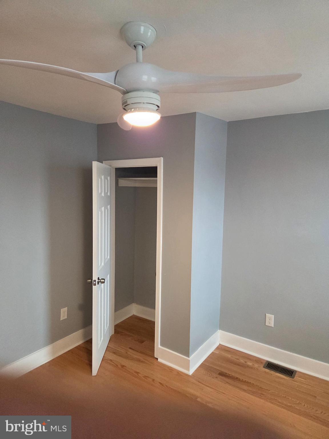 2609 East Hoffman Street Baltimore, MD 21213 - Photo 20 of 22 a view of a room with wooden floor and a ceiling fan