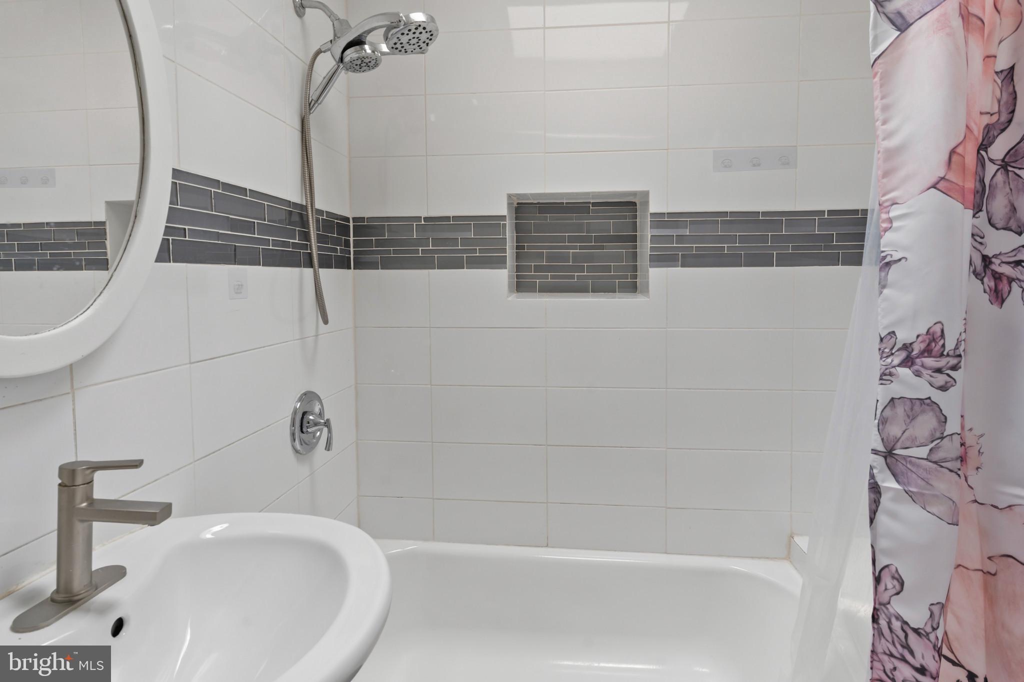 2609 East Hoffman Street Baltimore, MD 21213 - Photo 22 of 22 a bathroom with a bathtub and shower