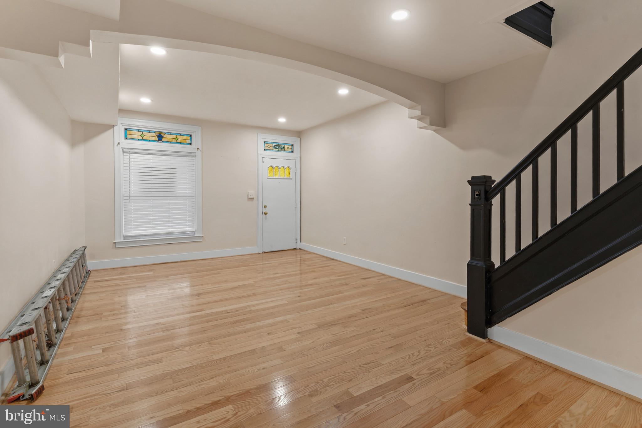 2609 East Hoffman Street Baltimore, MD 21213 - Photo 5 of 22 an empty room with wooden floor and windows