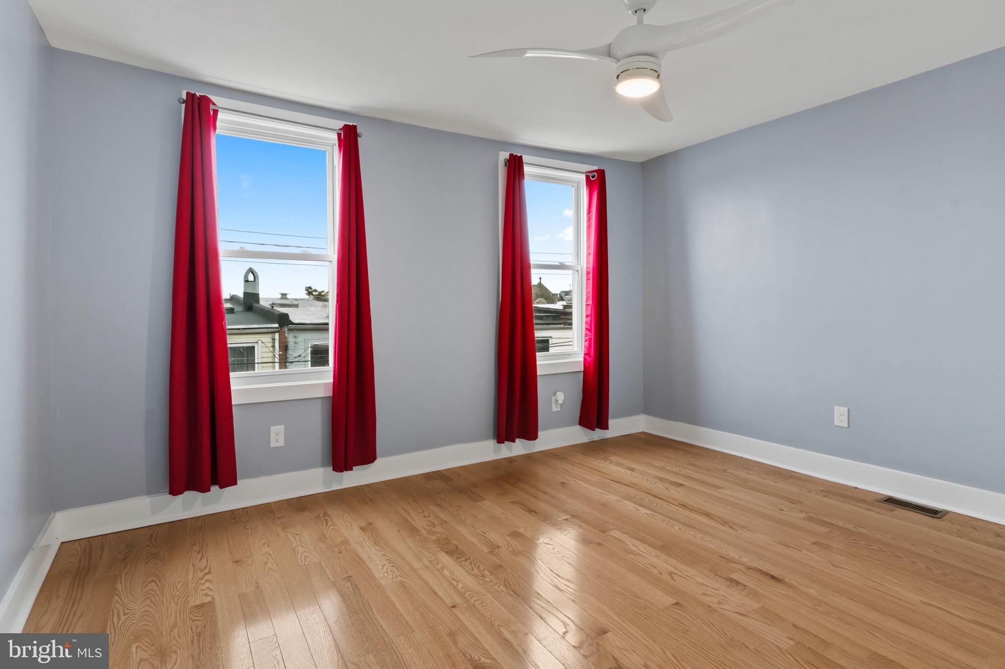 2609 East Hoffman Street Baltimore, MD 21213 - Photo 7 of 22 a view of a bedroom with closet and natural light