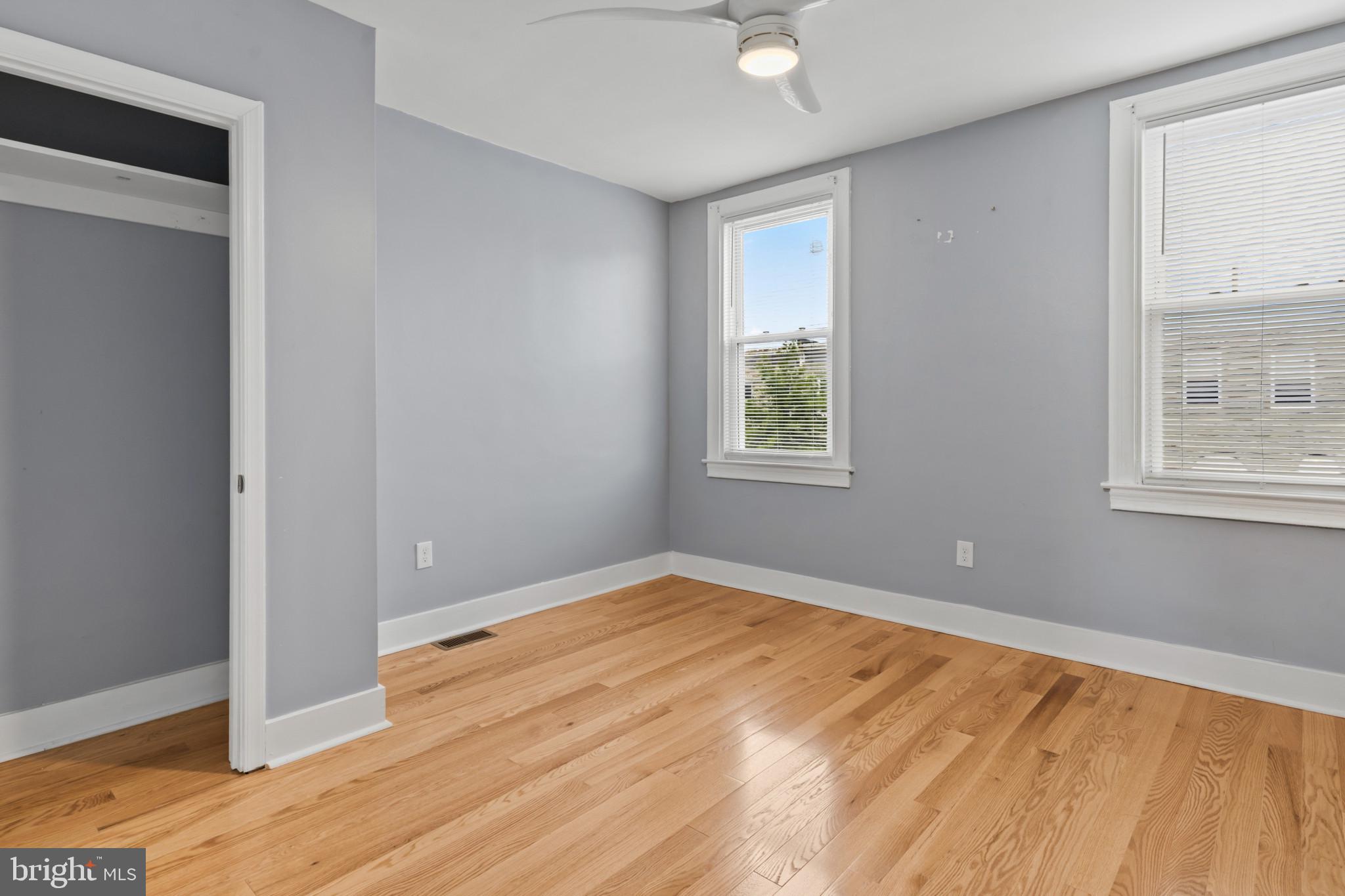 2609 East Hoffman Street Baltimore, MD 21213 - Photo 8 of 22 a view of an empty room with wooden floor and a window