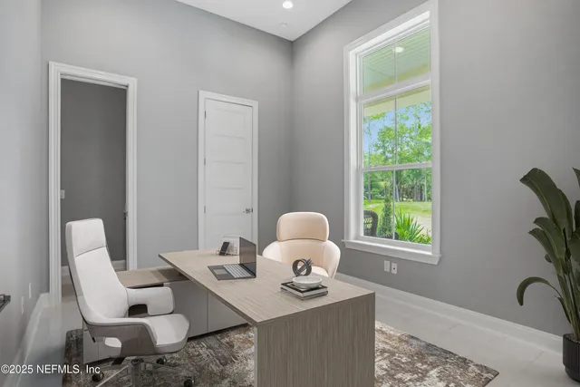 a living room with stainless steel appliances granite countertop furniture wooden floor and a window