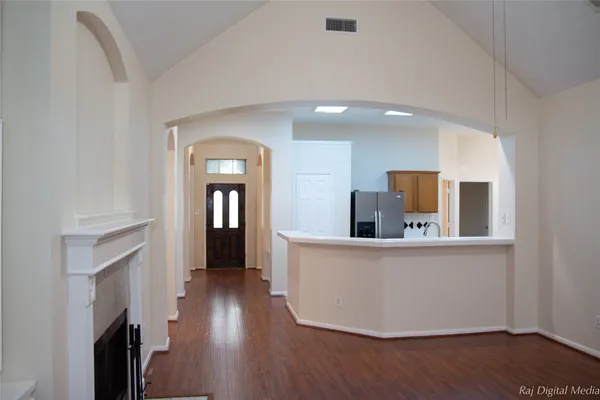 a living room with furniture and wooden floor