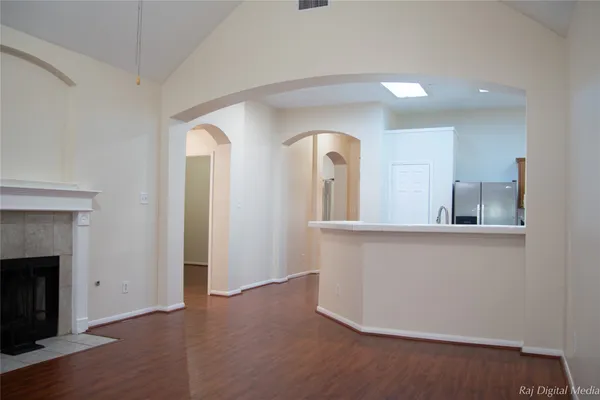 a view of living room with wooden floor and fireplace