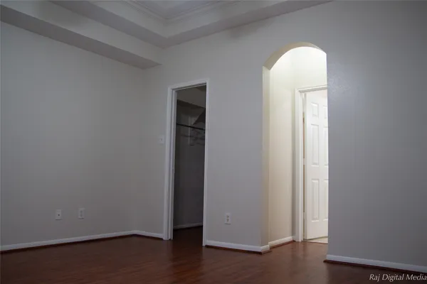 an empty room with wooden floor and closet