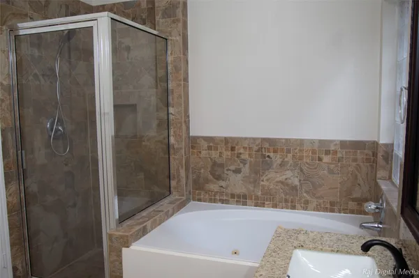 a bathroom with a bathtub and a shower