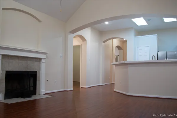 a view of a room with wooden floor and fireplace