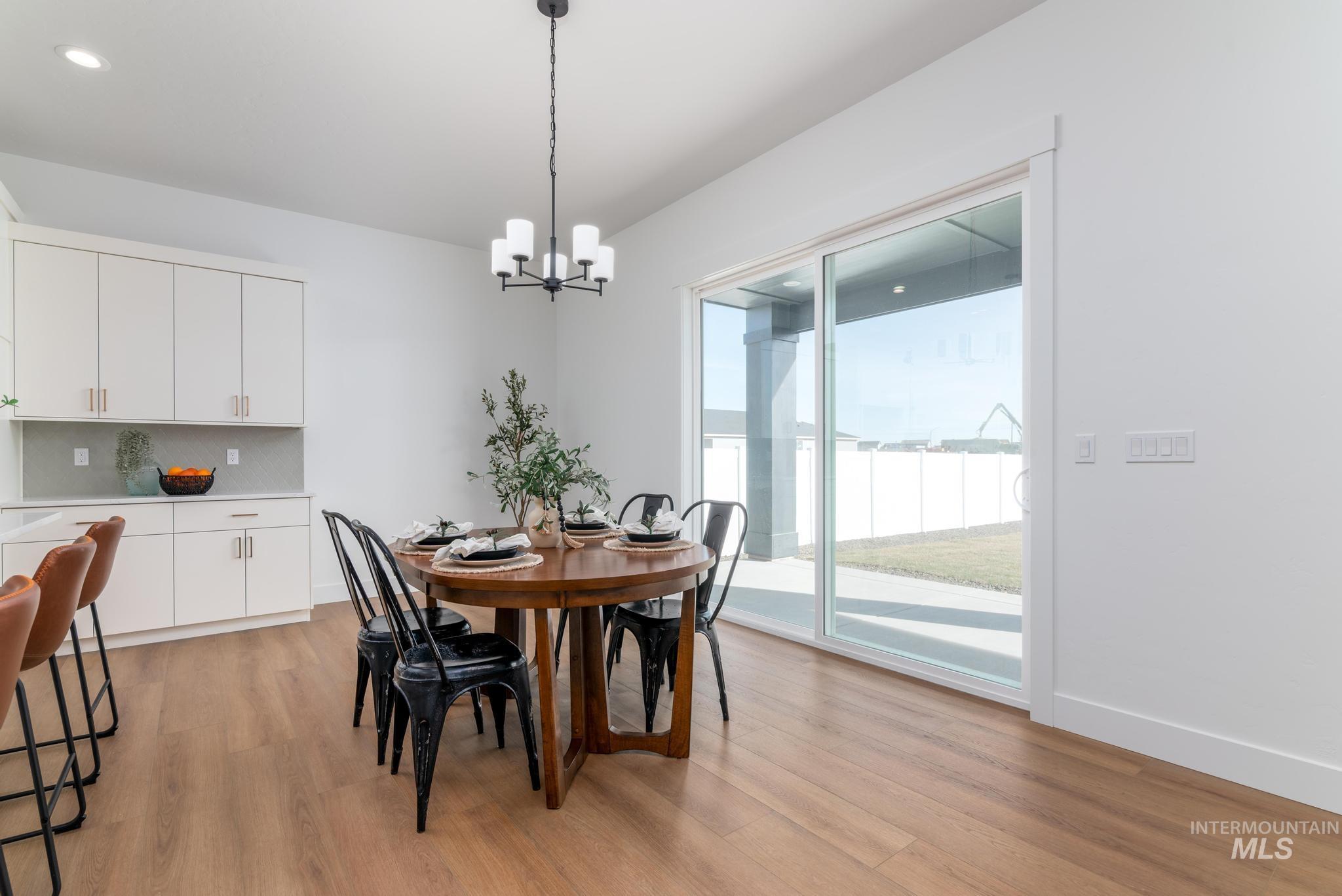 15142 Steel Cloud Avenue Caldwell, ID 83607 - Photo 11 of 44 Dining area featuring light wood-style flooring and a chandelier