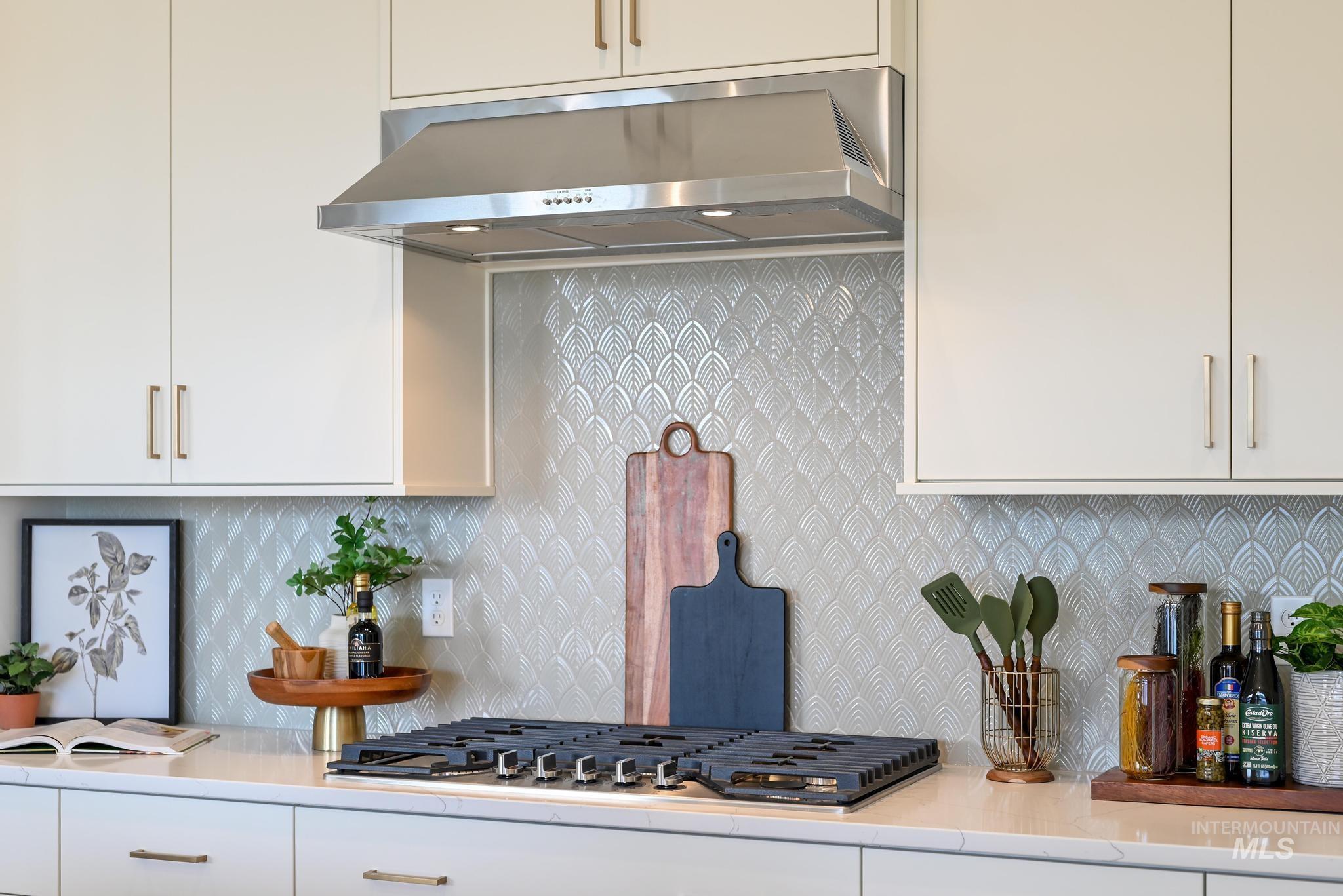 15142 Steel Cloud Avenue Caldwell, ID 83607 - Photo 12 of 44 Kitchen with backsplash, white cabinetry, and stainless steel gas stovetop