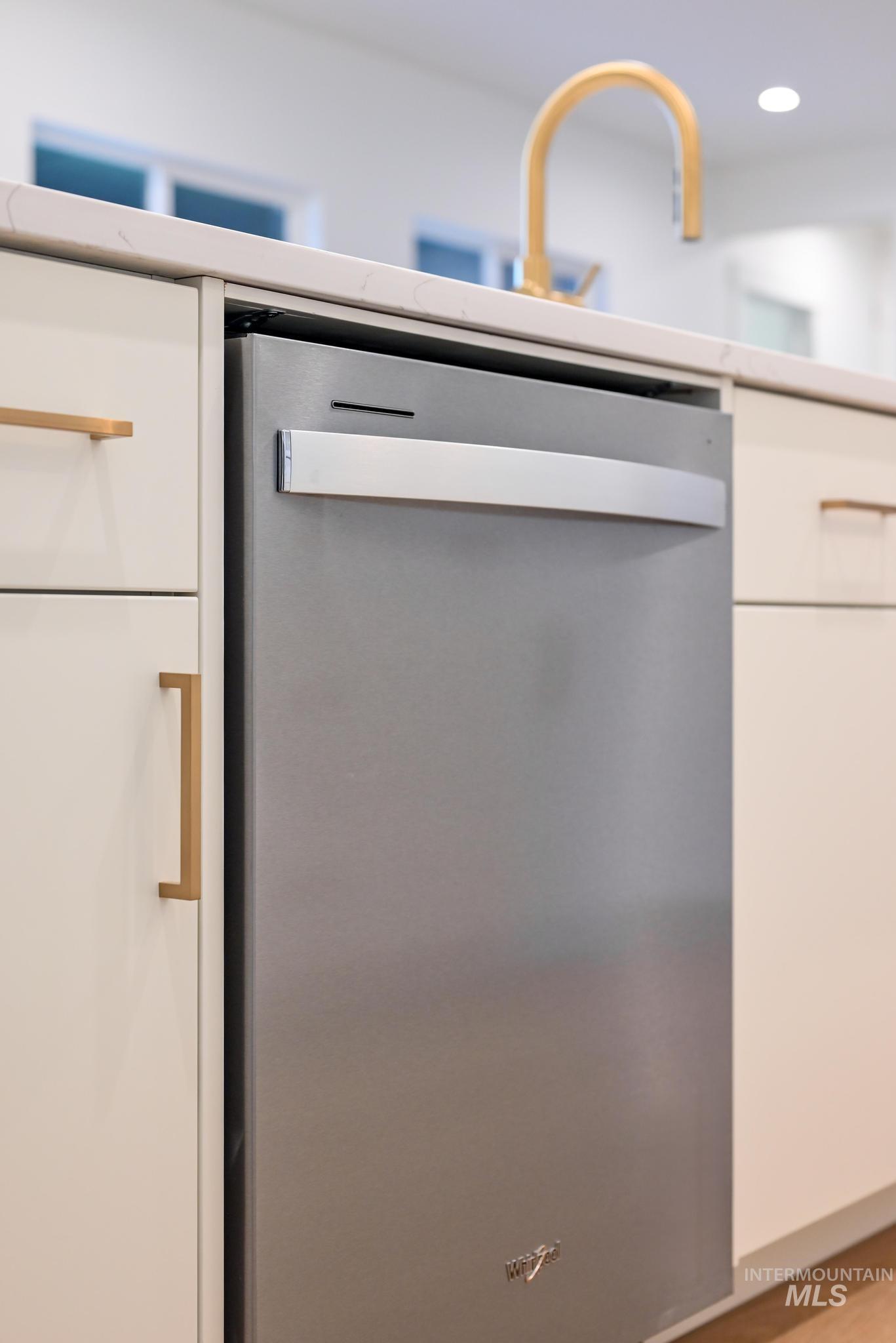 15142 Steel Cloud Avenue Caldwell, ID 83607 - Photo 14 of 44 Kitchen view of stainless steel dishwasher, white cabinets, recessed lighting, and light countertops