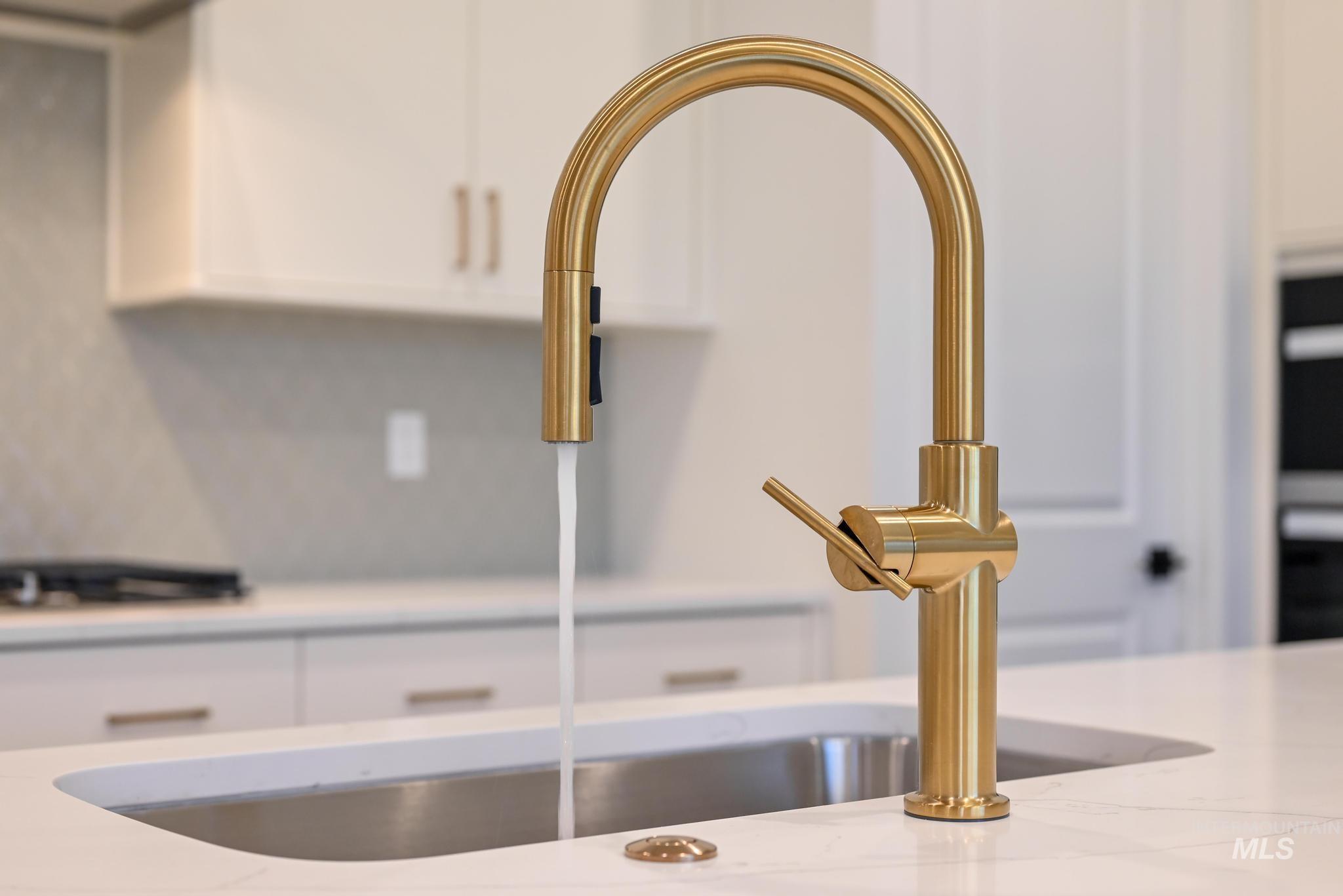 15142 Steel Cloud Avenue Caldwell, ID 83607 - Photo 15 of 44 Kitchen view of white cabinetry, stainless steel appliances, and light stone countertops